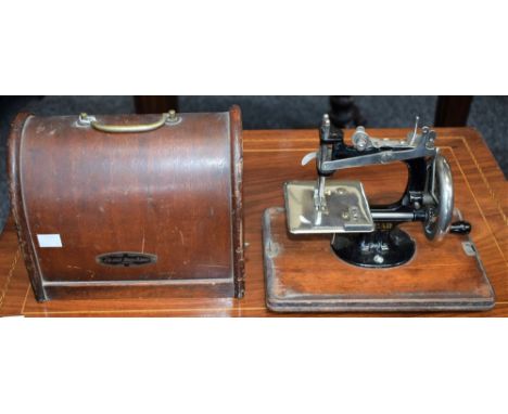 A Lead child's manual sewing machine, cased