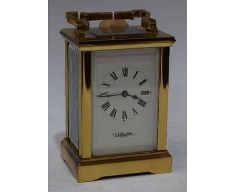 A 20th century Wellington brass carriage clock, bevelled glass, approx 11cm high excluding handle