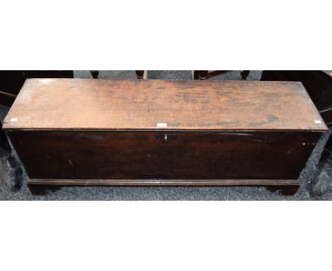 A late 18th century oak 'sword chest', hinged top, skirted base, bracket feet, 131.5cm wide