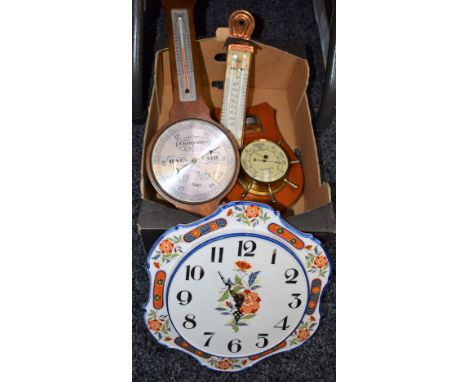 A shaped circular ceramic wall clock, painted with flowers; a ship's wheel barometer; another wheel barometer; a copper Brann