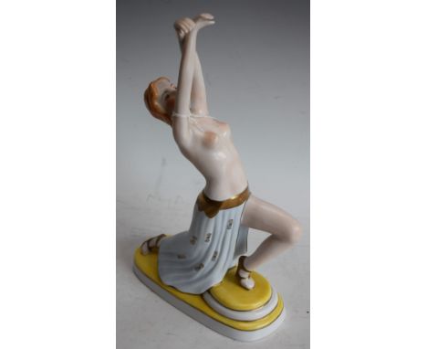 An Austrian Art Deco style porcelain figure, as a semi nude dancing girl, in the style of Royal Dux/Goldscheider, stamped Wie