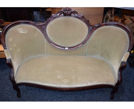 A Rococo Revival sofa, shaped cresting rail applied with C-scrolls and scrolling acanthus, scroll handrests, serpentine forel