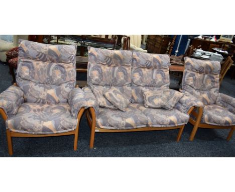 An Ercol elm framed two-seat sofa; a pair of conforming armchairs (3)