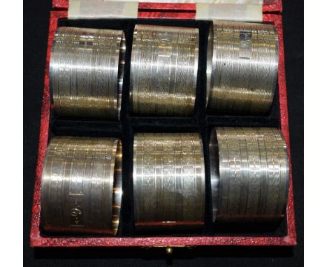 A set of six silver napkin rings, engine turned, marked Silver, cased