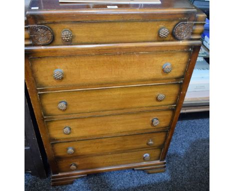 An Art Deco oak chest, stepped rectangular top with shaped half gallery above six long drawers, stepped bracket feet, 120cm h