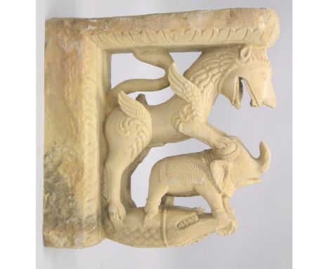 A LARGE 19TH CENTURY INDIAN CARVED ZOOMORPHIC YELLOW STONE ARCHITECTURAL ELEMENT, carved with mythical beast, elephant and cr