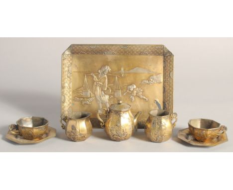 AN EARLY 20TH CENTURY JAPANESE GILDED &amp; SILVERED SOFT METAL MINIATURE PART TEA SERVICE, comprising a tray, a teapot, a su