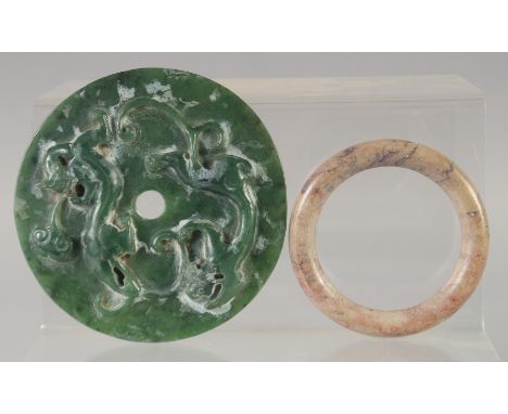 A CHINESE JADE DISK, with calligraphy and lion dogs, together with a hardstone bangle, (2).