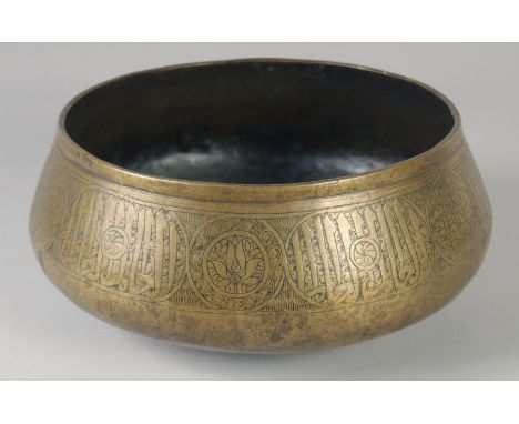 A FINE 14TH CENTURY MAMLUK RASULID BRASS BASIN, with engraved calligraphic panels, 26cm diameter.