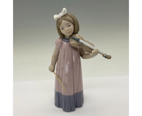 A glazed figure of a young girl playing a string instrument. Nao backstamp. This item has its original box: 5.25"L x 10"W x 4