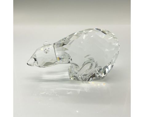 A clear crystal polar bear with diamond shaped cuts throughout its body with black crystal used for the eyes and snout. Swaro