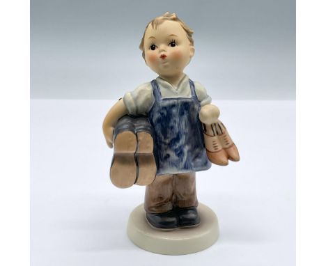 An adorable boy holding two pairs of shoes. Goebel Hummel backstamp. 143/0. Issued: 20th centuryDimensions: 2.75"L x 2"W x 5.
