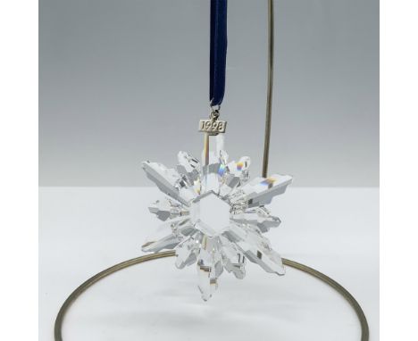 Limited edition crystal ornament with a metal tag reading 1998 as well as 6 short points and 6 long points that depict a beau