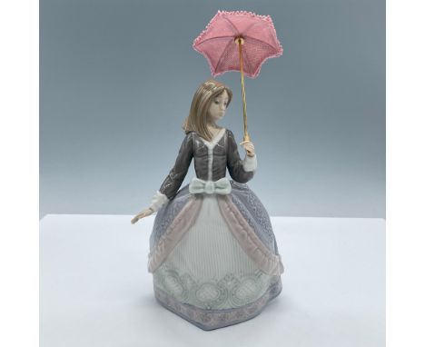 Glossy porcelain. Depicts a young lady in an elegant dress with a lace umbrella. Lladro backstamp. This item has its original