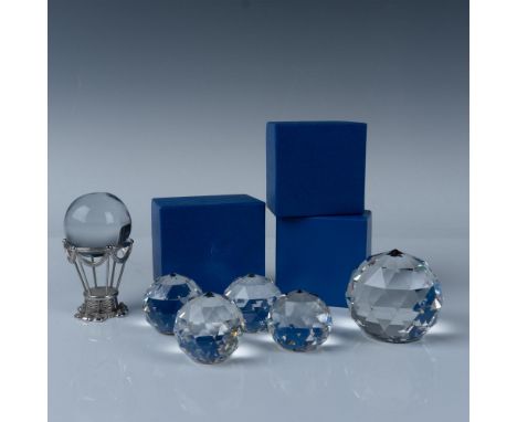 A set of six paperweights, including four small carved paperweights with vibrant rainbow interiors, one larger paperweight wi