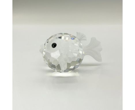 A clear and frosted faceted figure of a puffer fish with black eyes. Swarovski backstamp. This item has its original box: 5"W