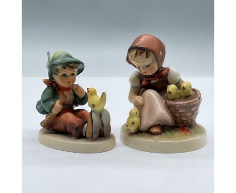 These adorable porcelain figurines feature a seated boy singing with the yellow bird that is perched upon his shoes and a swe