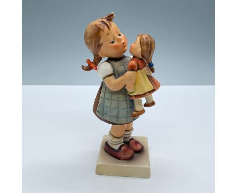 Hand painted in matte finish modeled as a young girl playing with her doll. M. I. Hummel impressed signature. Goebel backstam