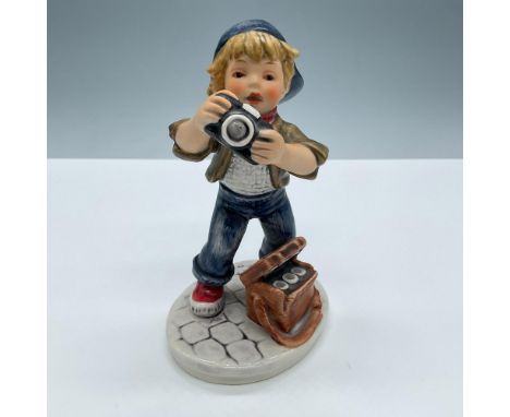 Beautiful matte finish. Features a little boy taking photographs. Signed Frobek. Goebel Hummel Today's Children backstamp. Is