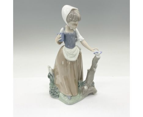This charming glossy figurine depicts a young girl reaching out to a pretty butterfly. This item has its original box: 6.25"L