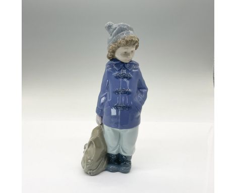 This glossy figurine depicts a boy in his winter gear and bag, ready for an adventure. Nao backstamp. This item has its origi