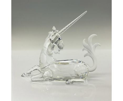 Brilliant cut crystal figure of a majestic unicorn lying down with satin horn, tail and mane. Swarovski etched mark. The Unic