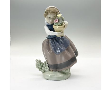 Glossy figure of a young woman holding potted flowers. Lladro backstamp. This item has its original box: 4.75"L x 4.5"W x 8"H