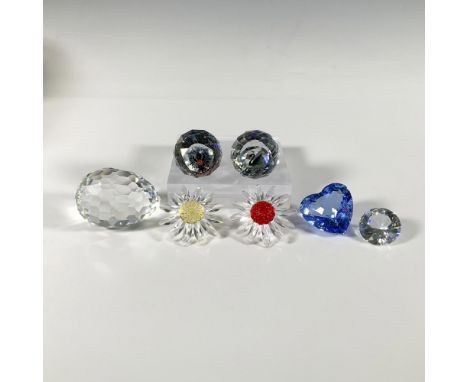 Seven multi-faceted crystal figures, including two marguerites, a blue heart, a small chaton, an egg paperweight, an SCS Blac