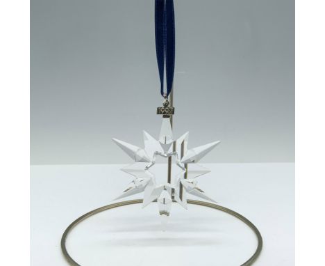 Limited edition crystal ornament with a metal tag reading 1997 as well as 6 short points and 6 long points that depict a beau