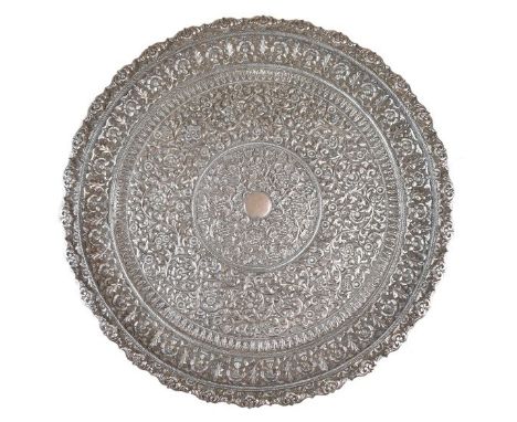 Indian white metal salver, having allover embossed floral decoration standing on four scroll feet, 38cm diameter, 44.5toz app