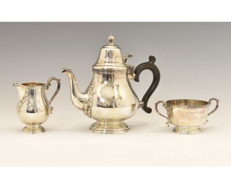 Elizabeth II three piece tea set, in the Queen Anne style with applied decorative mounts to the handles and spout, sponsors m