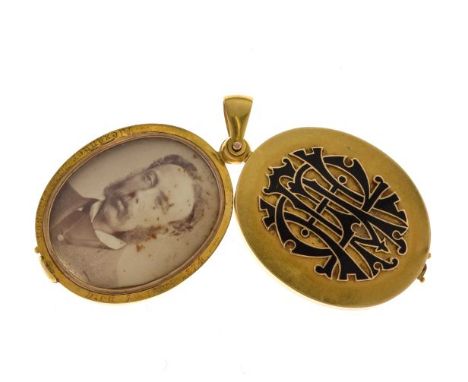 Victorian gold locket, with applied black enamel monogram, swing open action, containing a photograph of a gentleman inscribe