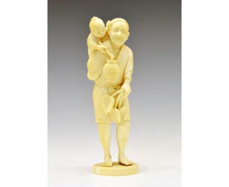 Japanese Meiji period carved ivory okimono, of an old man, a young child on his back holding a lantern or vessel, incised two