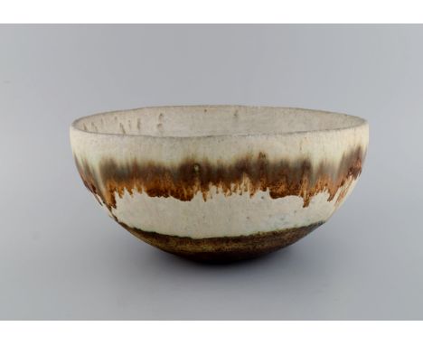European studio ceramicist. Large unique bowl in glazed ceramics. Beautiful running glaze in light earth shades. 1960s / 70s.