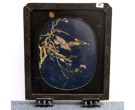 A 19th / early 20th century Japanese carved and lacquered double sided fire screen with mother of pearl and carved bone decor