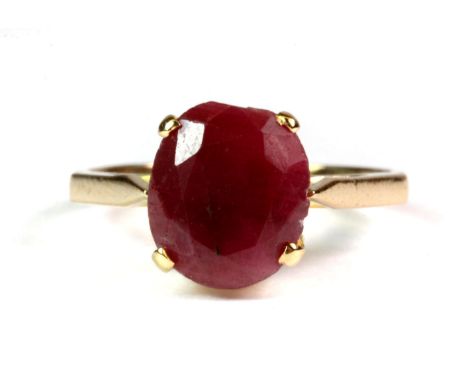 A yellow metal (tested 22ct gold) ring set with a large oval cut ruby (approx 2ct) (L).