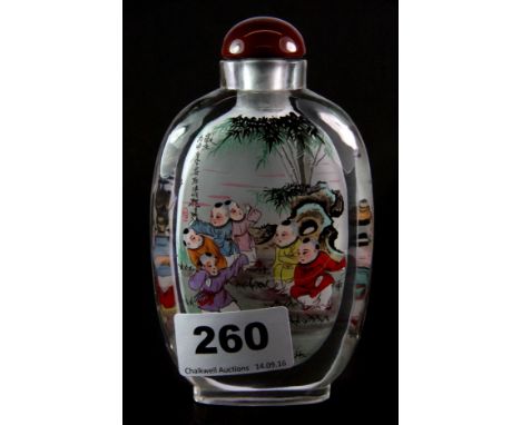A large Chinese signed inside painted lead crystal snuff bottle of children playing in a park, H. 13cm.