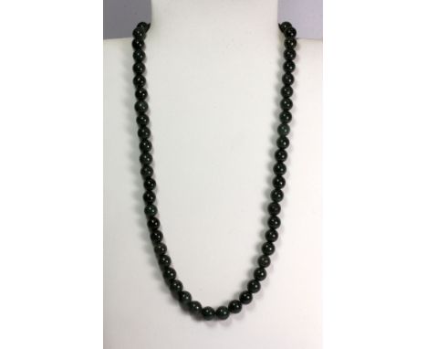 A lovely dark green jade bead necklace.
