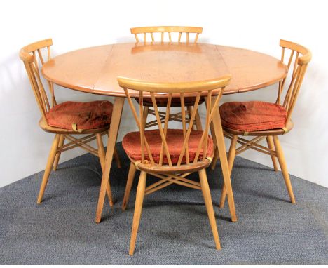 An Ercol circular drop leaf table and four chairs.