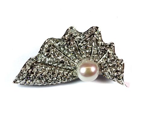 A 925 silver brooch set with a cultured pearl and cubic zirconias.