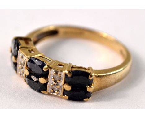 9ct gold ring set with 6 octagon cut sapphires and 4 diamond spacers. Size P. Gross weight: 3g