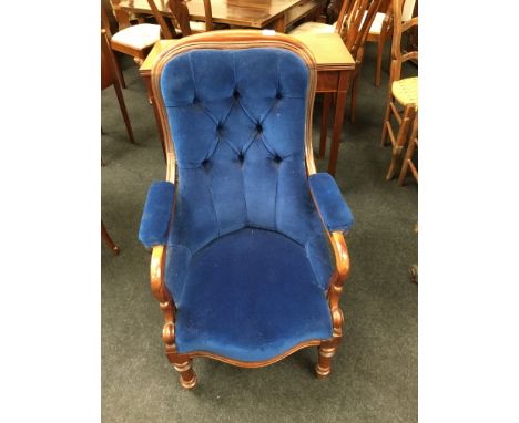 A Victorian rosewood and button backed easy chair with padded backs in blue velour, padded arms, swan necked arm supports, re