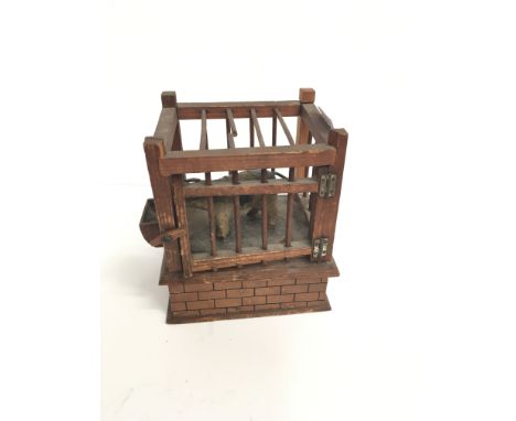 TREEN: A Victorian automaton trick wooden toy modelled as a Pig in a cage with lockable gate, when opened the pig swings out 