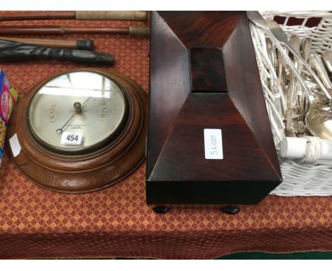 A 19th century rosewood tea caddy (no fittings) together with an oak cased circular barometer by James Lucking & Co., Birming