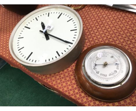 A circular GPO (Post Office) metal framed wall clock No. 630819 together with an oak framed wall barometer.(R7)