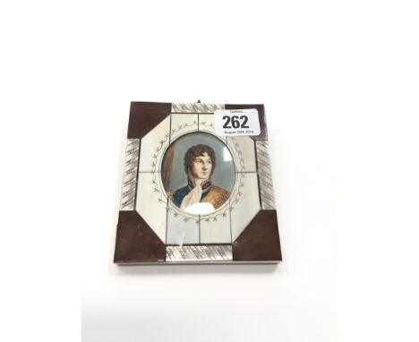 A painted portrait miniature in Mother of Pearl and inlaid wooden frame.