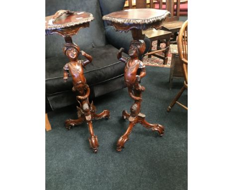 A pair of mahogany and beech Florentine designed torcheres, designed as Young Gallants resting on tripod base, decorated all 