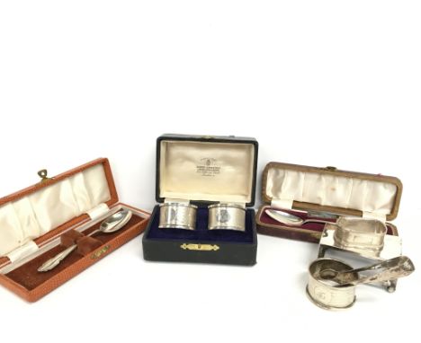 A cased pair of engine turned serviette rings together with two cased silver teaspoons, silver matchbox holder, two odd silve