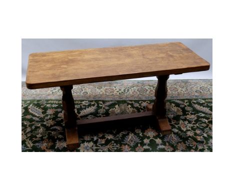 Robert Mouseman Thompson of Kilburn- an oak rectangular lcoffee table, adzed top on octagonal baluster supports joined by flo