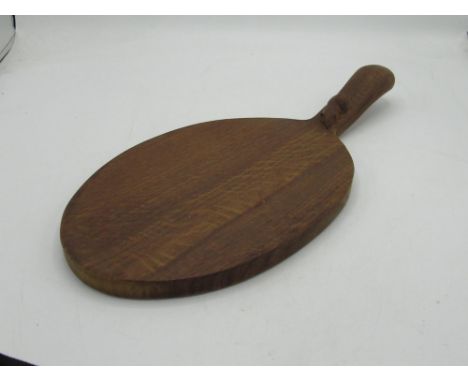 Robert Mouseman Thompson of Kilburn - an oak oval cheese board, curved handle carved with signature  mouse, L38cm W18cm 